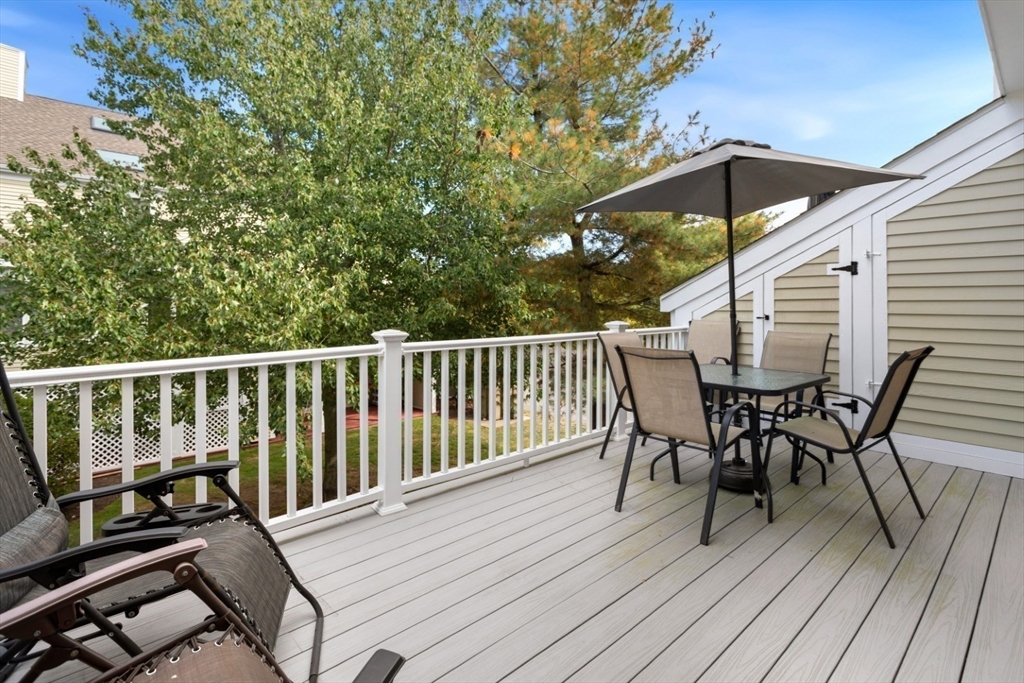 108 Abington Road, Unit 108 Danvers, MA 01923 - Photo 30 of 34 a view of a roof deck with table and chairs