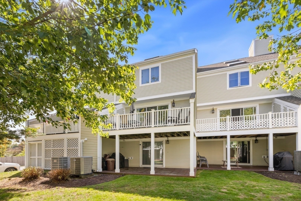 108 Abington Road, Unit 108 Danvers, MA 01923 - Photo 32 of 34 a front view of a building with a garden