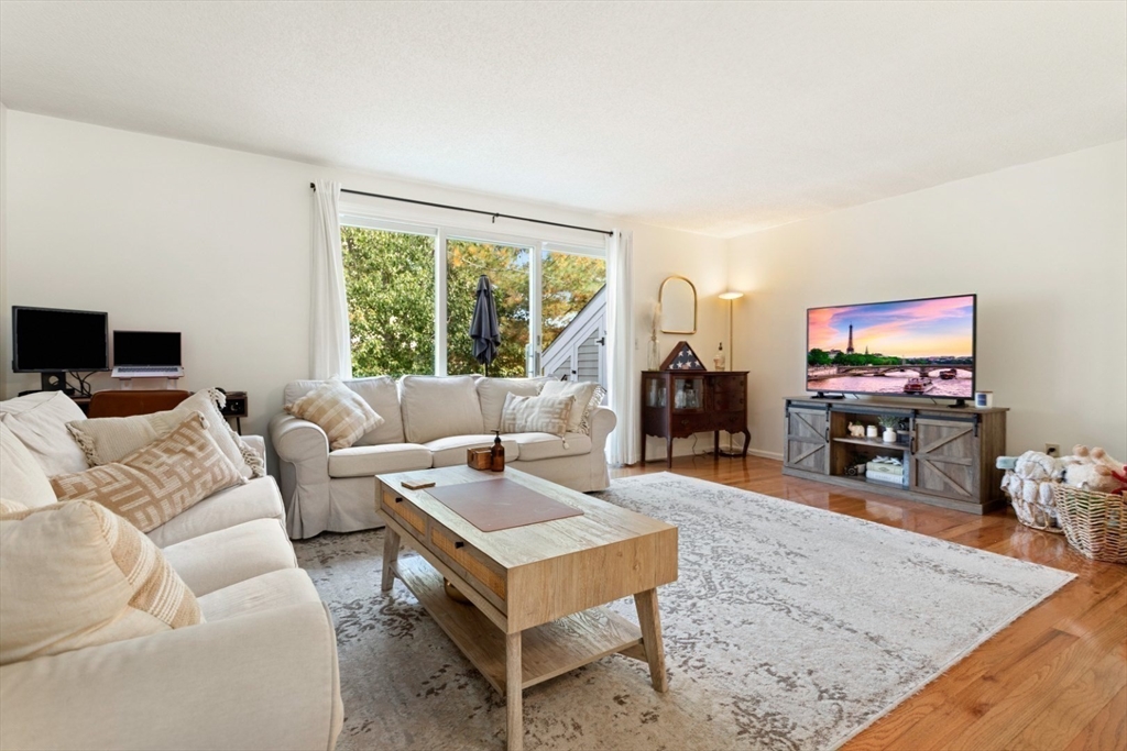 108 Abington Road, Unit 108 Danvers, MA 01923 - Photo 10 of 34 a living room with furniture and a flat screen tv