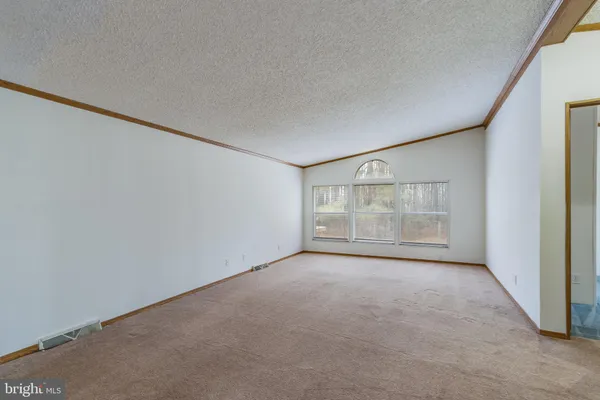 a view of an empty room with a fireplace