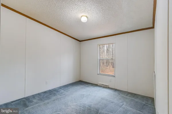 a view of an empty room with windows