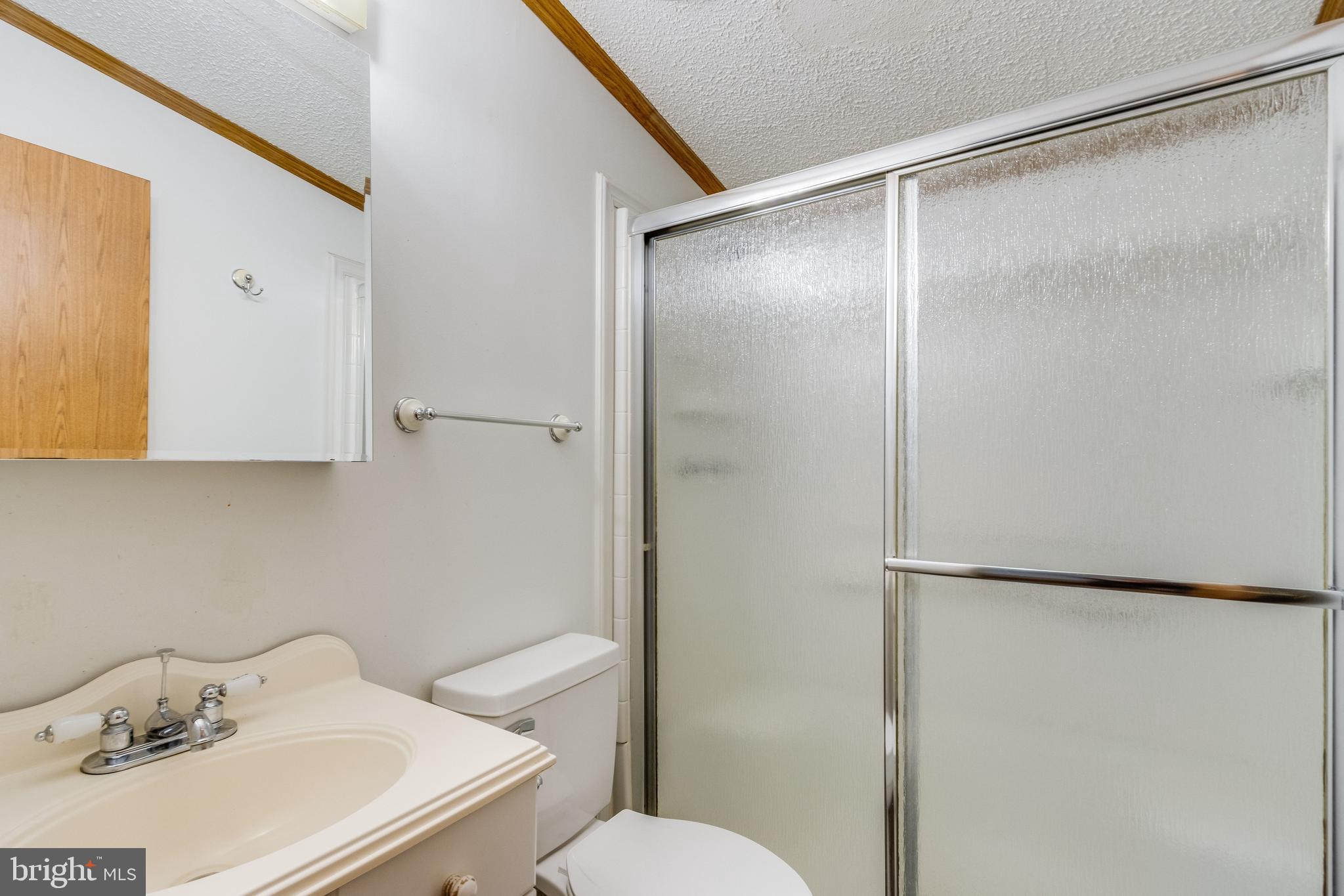2578 Williamsville Road Houston, DE 19954 - Photo 26 of 52 a bathroom with a sink toilet and shower