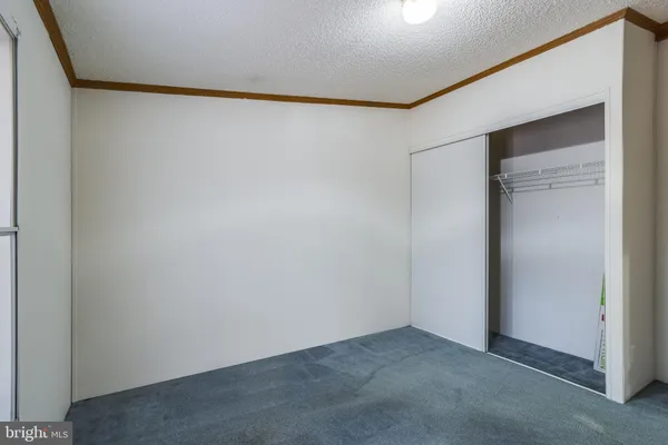 a kitchen with stainless steel appliances granite countertop a stove top oven a sink a dining table and chairs