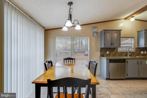 a kitchen with cabinets appliances and a dining table