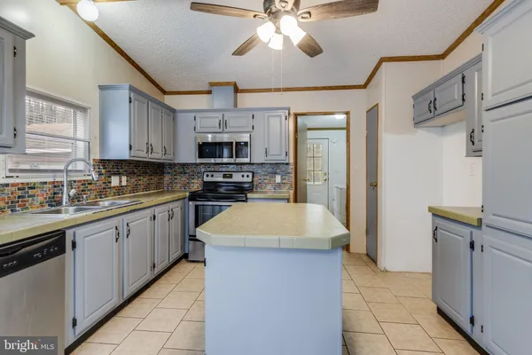 a kitchen with cabinets a sink and stainless steel appliances