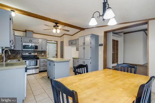 a kitchen with a table and chairs in it
