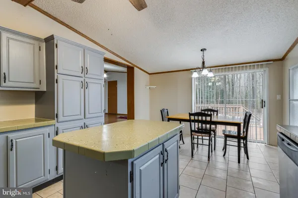 a kitchen with lots of counter top space and dining table