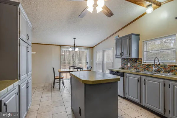 a kitchen with stainless steel appliances granite countertop a sink a stove and cabinets