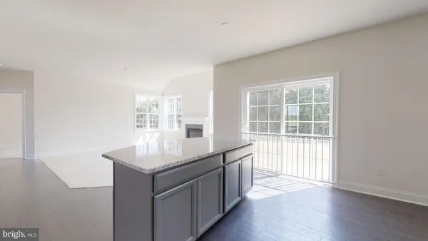a kitchen with kitchen island a large counter top space a sink stainless steel appliances and cabinets