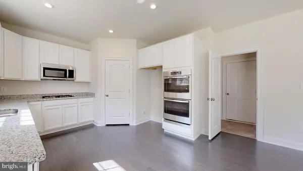 a kitchen with stainless steel appliances granite countertop a sink and a stove