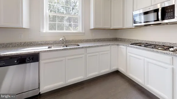 an empty room with windows and fireplace