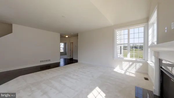 a view of staircase with white walls and a window