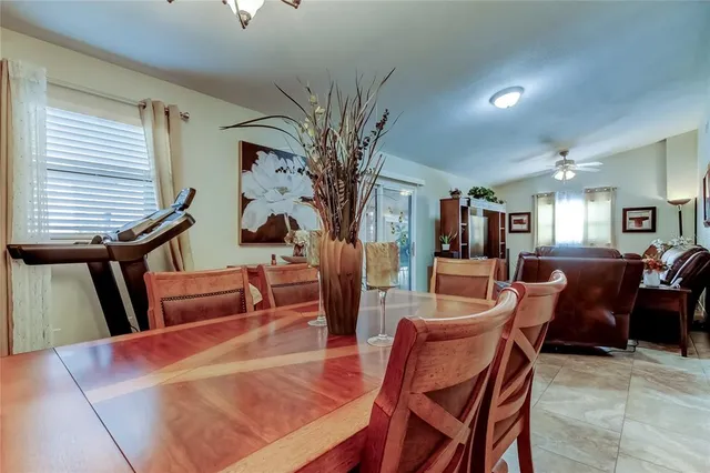a living room with furniture a piano and a bookshelf