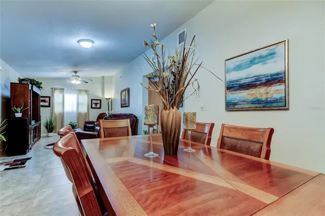 a living room with furniture large mirror and a flat screen tv