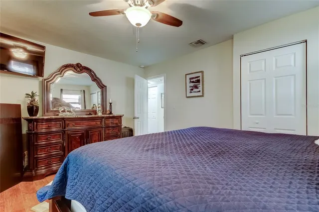a bedroom with a large bed and a chandelier