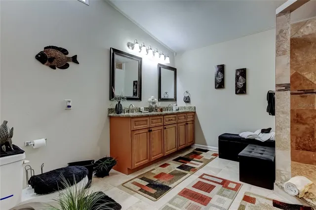 a bedroom with furniture and a mirror