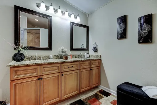 a bathroom with a double vanity sink and a mirror