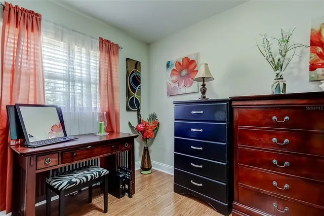 a view of a workspace with furniture and a window