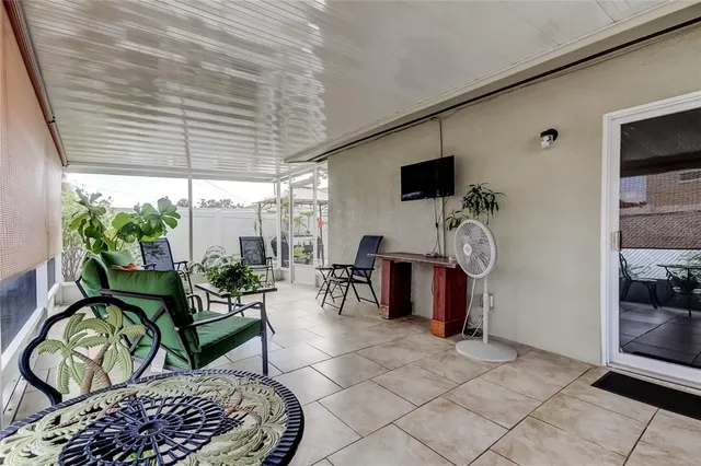 a living room with furniture a flat screen tv and a window