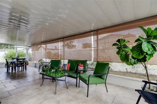 a living room filled with furniture and a potted plant