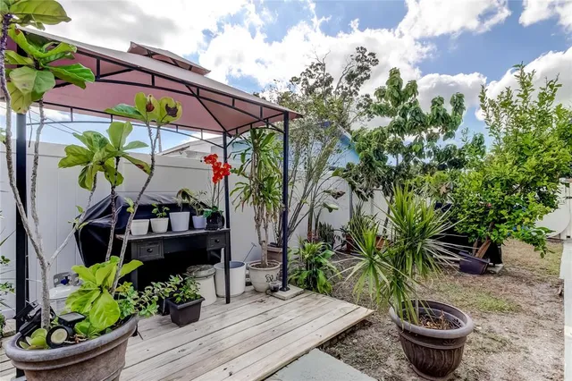 a vase of flowers sitting on a floor