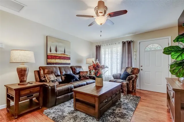 a living room with furniture a chandelier and a rug
