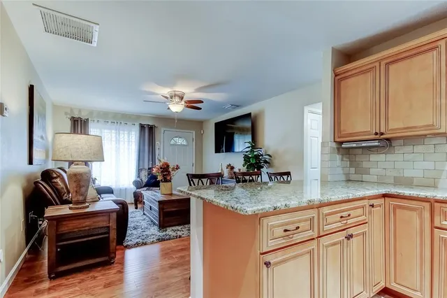 a living room with granite countertop furniture and fireplace
