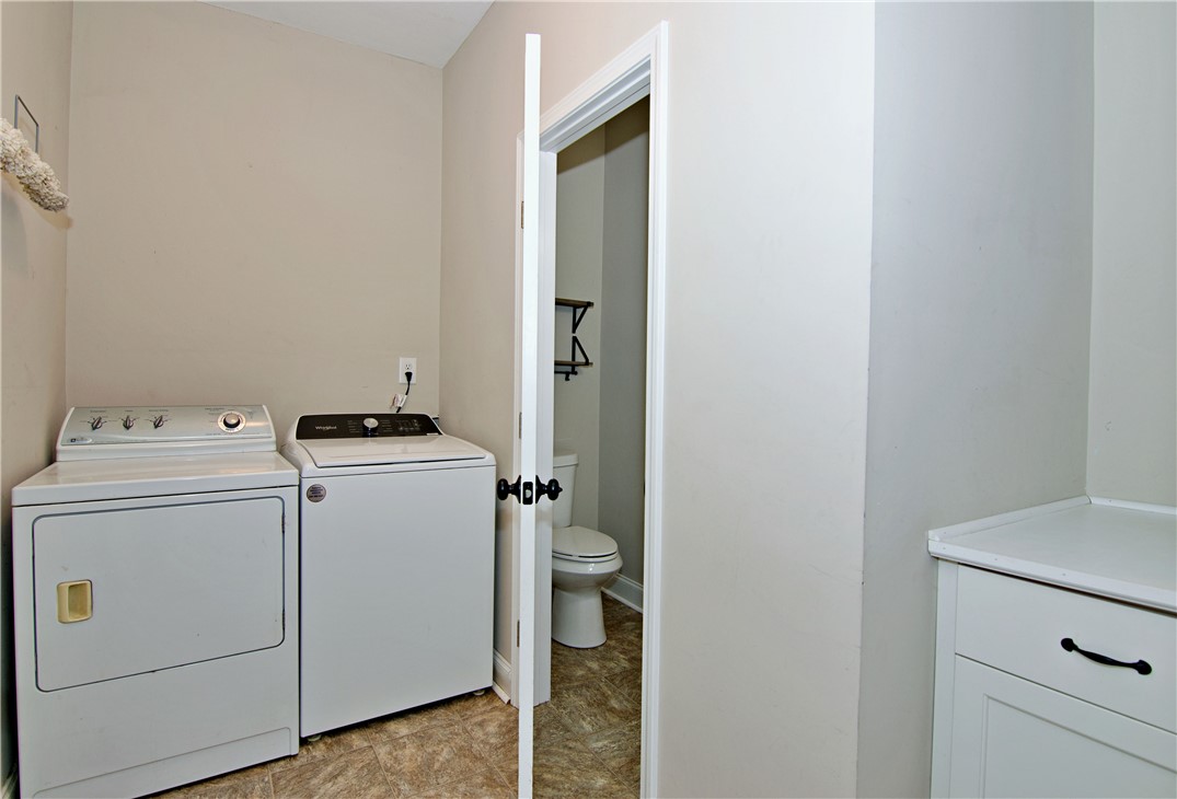 7893 Athens Road Carnesville, GA 30521 - Photo 30 of 50 This dedicated space offers convenience with essential laundry appliances and easy access to a nearby restroom.