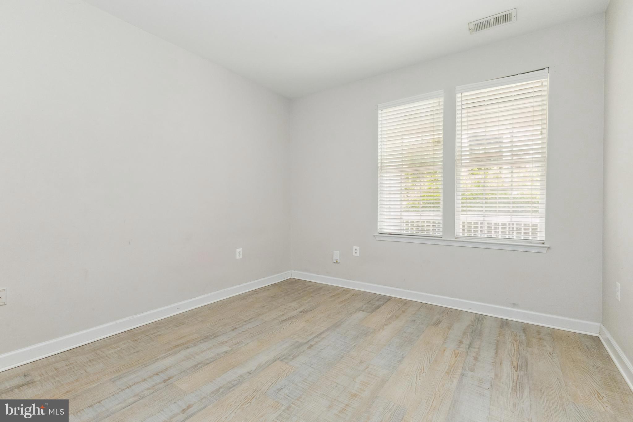 22664 Blue Elder Terrace, Unit 102 Brambleton, VA 20148 - Photo 13 of 25 an empty room with a window
