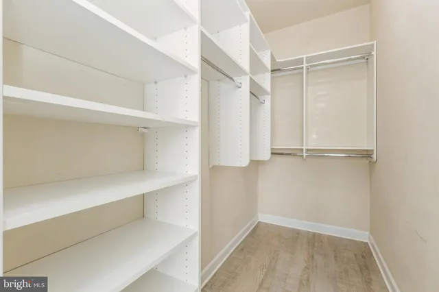 a view of walk in closet with empty racks