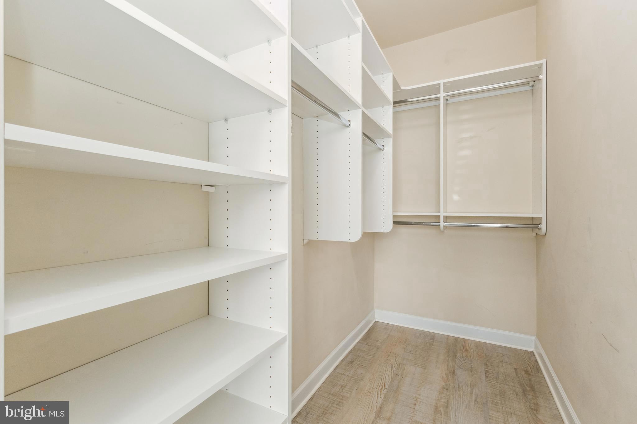 22664 Blue Elder Terrace, Unit 102 Brambleton, VA 20148 - Photo 16 of 25 a view of walk in closet with empty racks