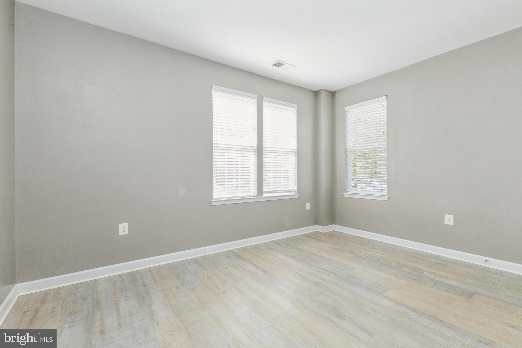 22664 Blue Elder Terrace, Unit 102 Brambleton, VA 20148 - Photo 17 of 25 wooden floor in an empty room with a window