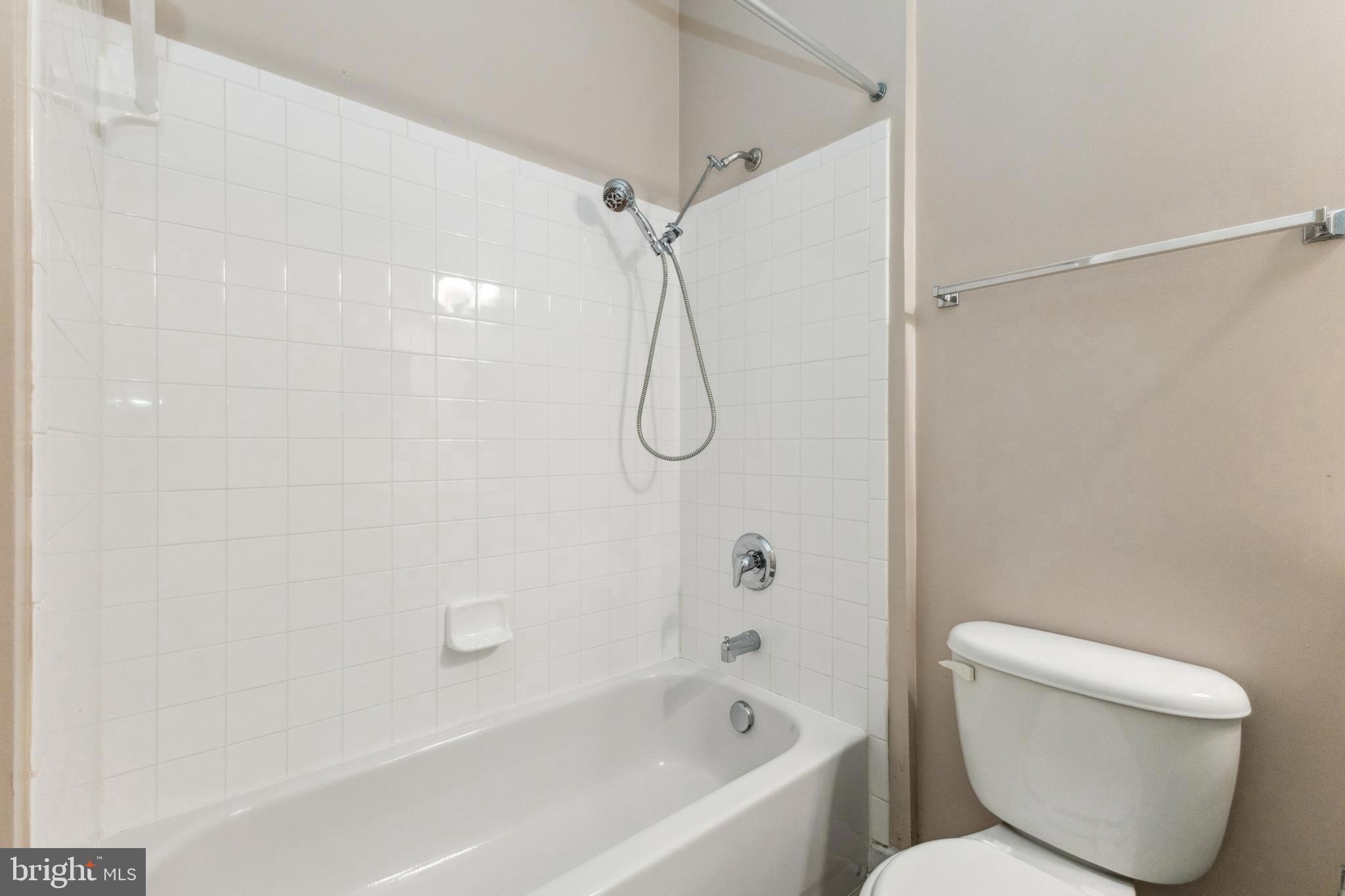 22664 Blue Elder Terrace, Unit 102 Brambleton, VA 20148 - Photo 19 of 25 a bathroom with a toilet and a shower