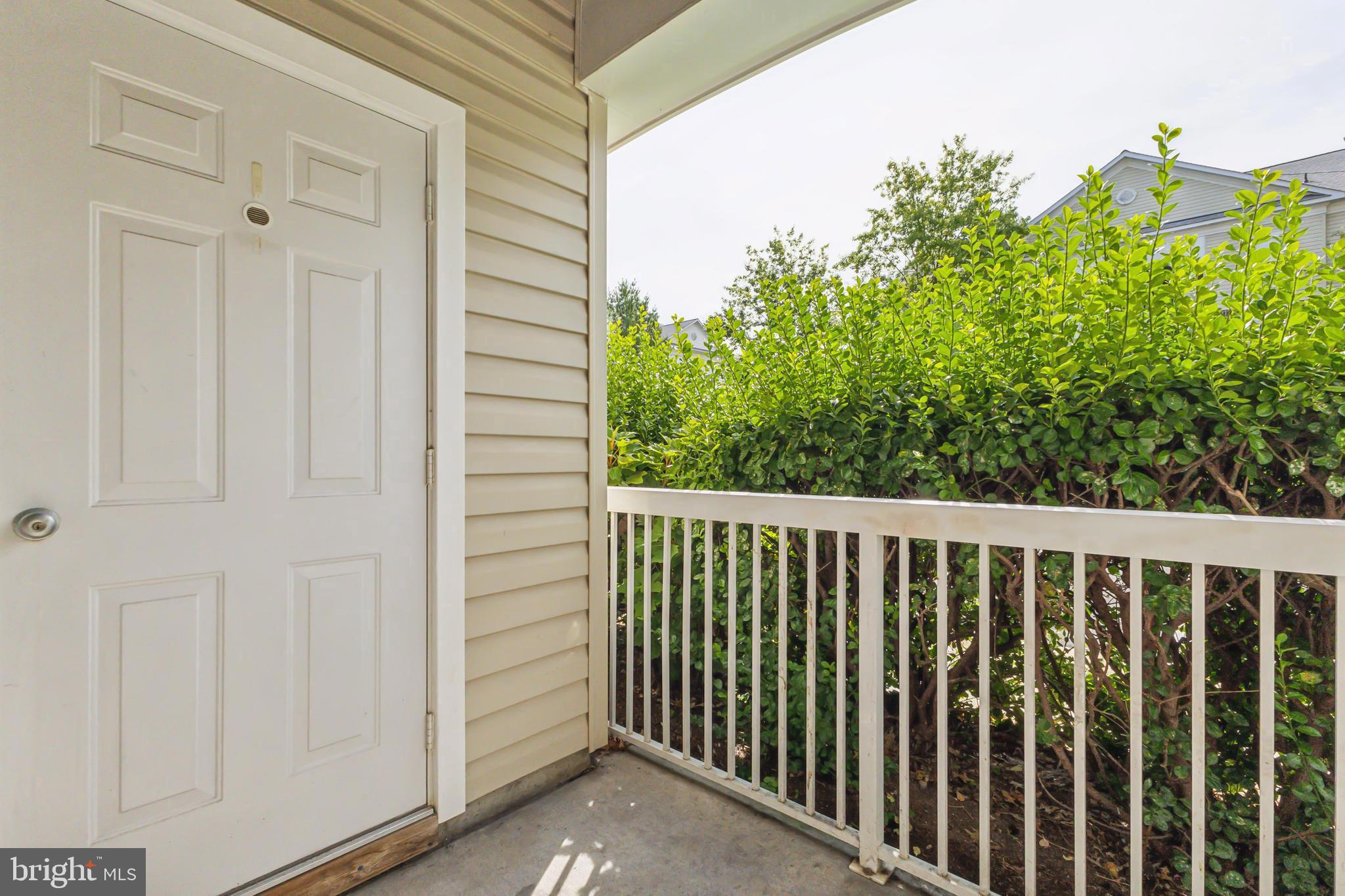 22664 Blue Elder Terrace, Unit 102 Brambleton, VA 20148 - Photo 22 of 25 a view of a balcony with an outdoor space