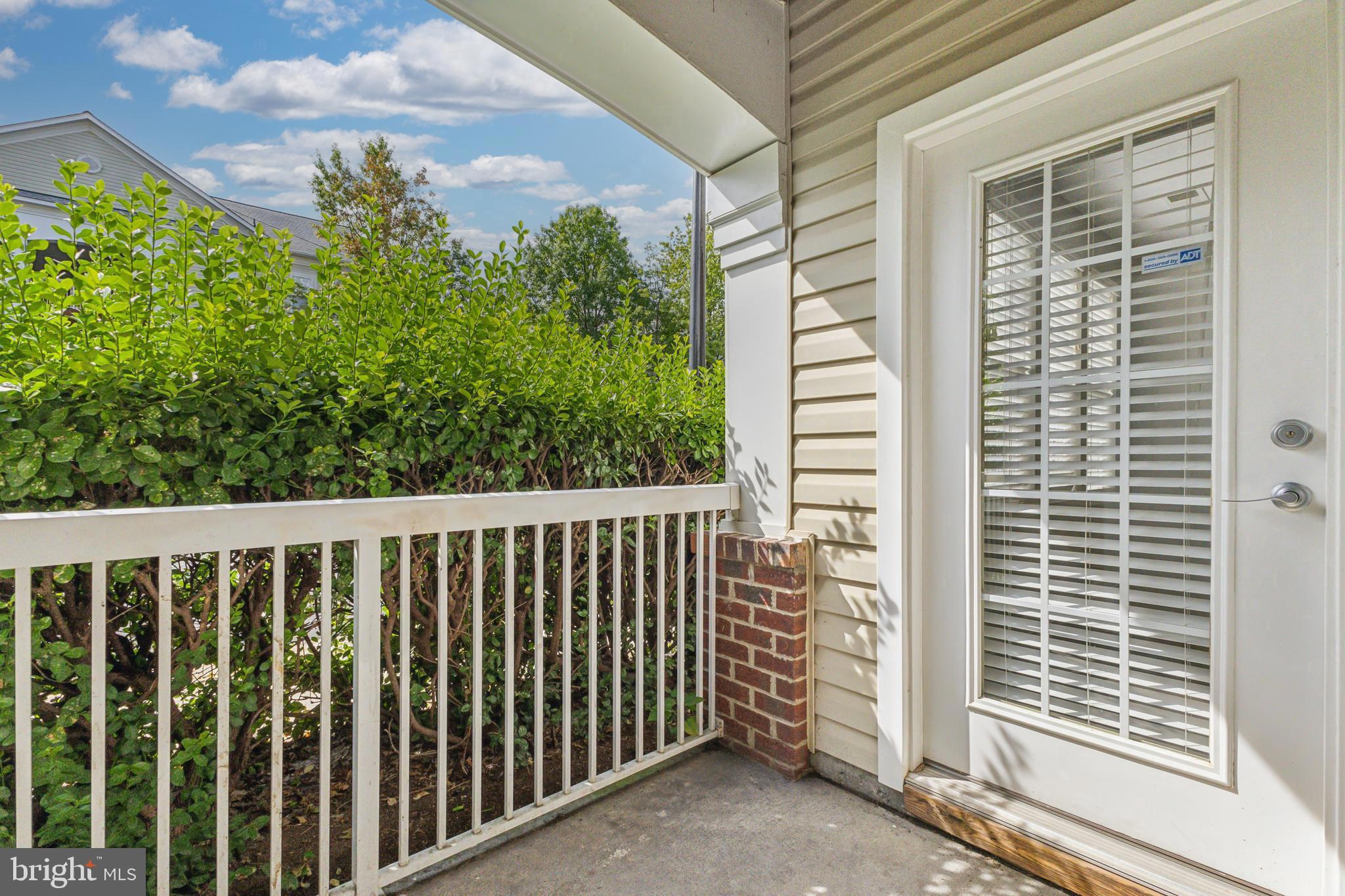 22664 Blue Elder Terrace, Unit 102 Brambleton, VA 20148 - Photo 23 of 25 a view of a porch with a yard