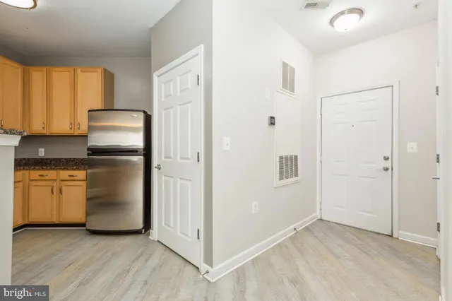 a kitchen with granite countertop white cabinets and stainless steel appliances