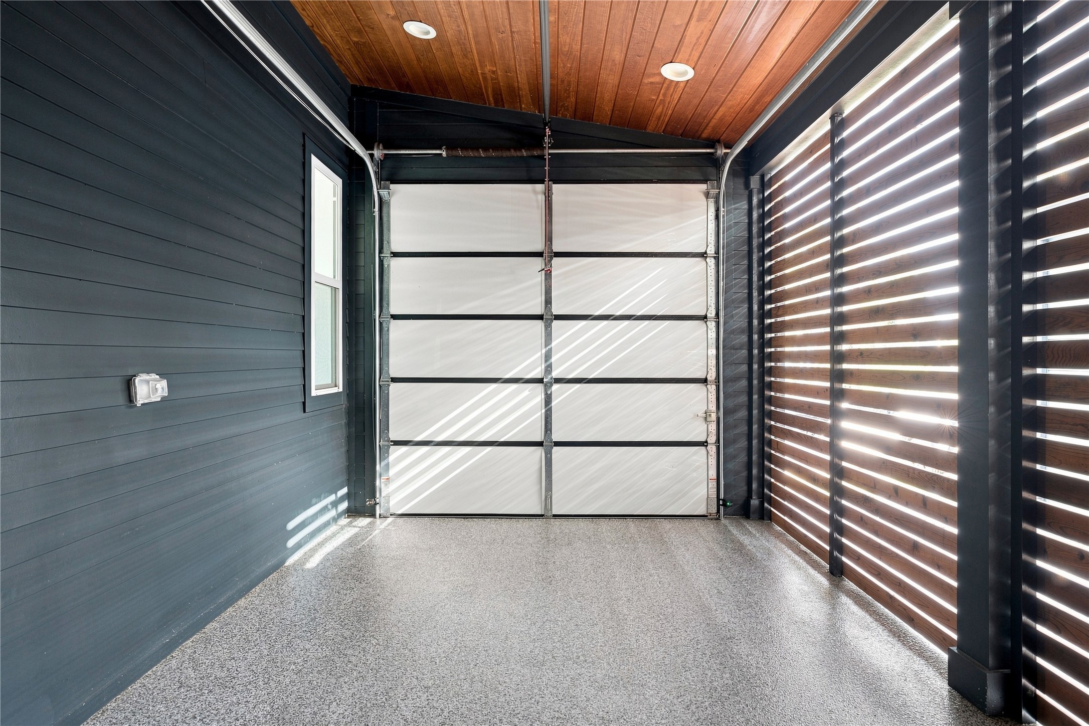 5506 Hudson Street, Unit 2 Austin, TX 78721 - Photo 20 of 24 Natural wood plank ceilings and epoxy flooring define this modern covered parking space.