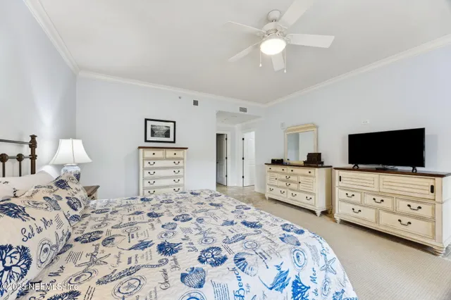 a view of a dining room with furniture a chandelier and wooden floor
