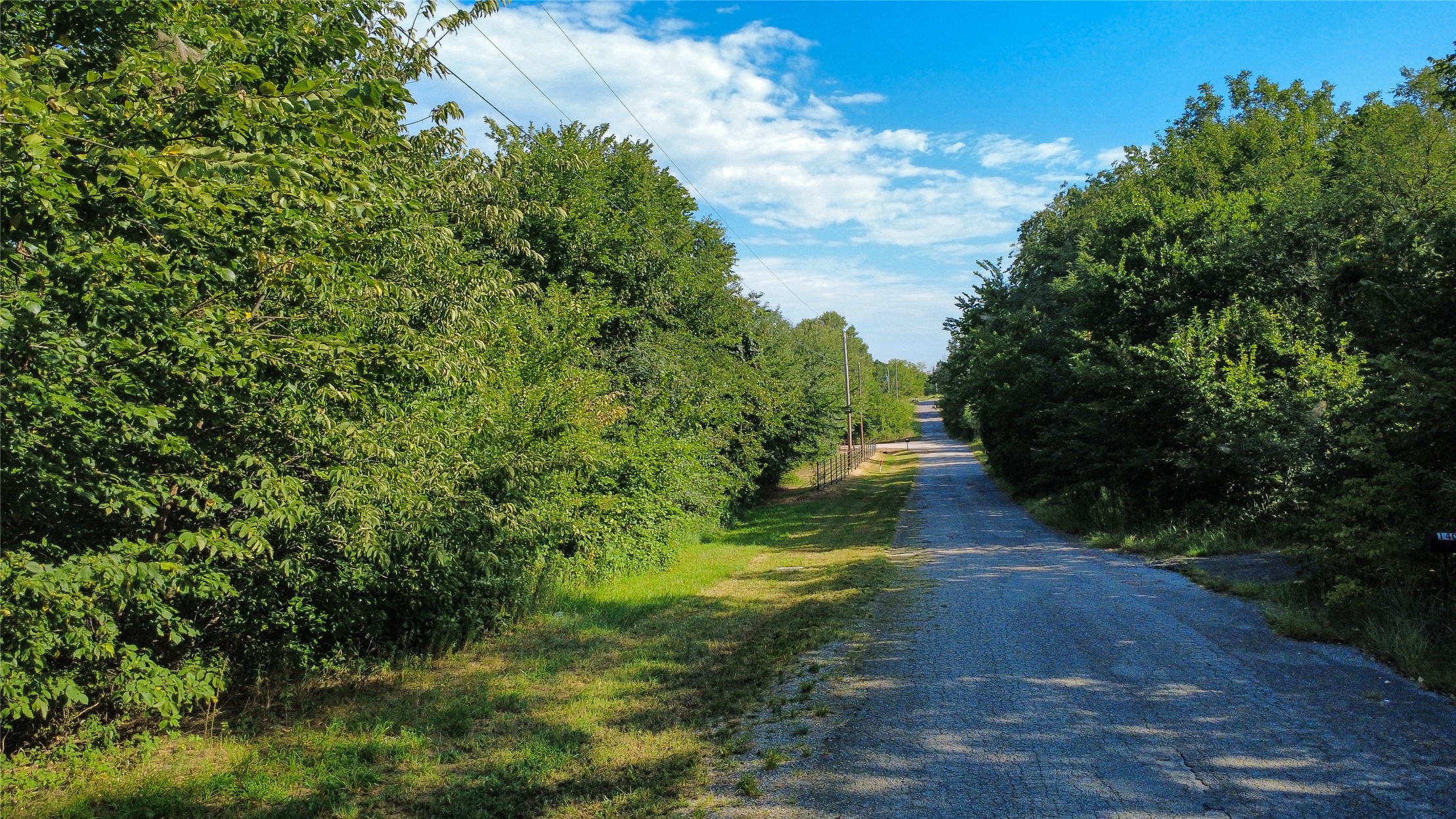 Pleasant Ridge Jones, OK 73049 - Photo 7 of 21 Gravel road bordered by mature trees and natural landscaping
