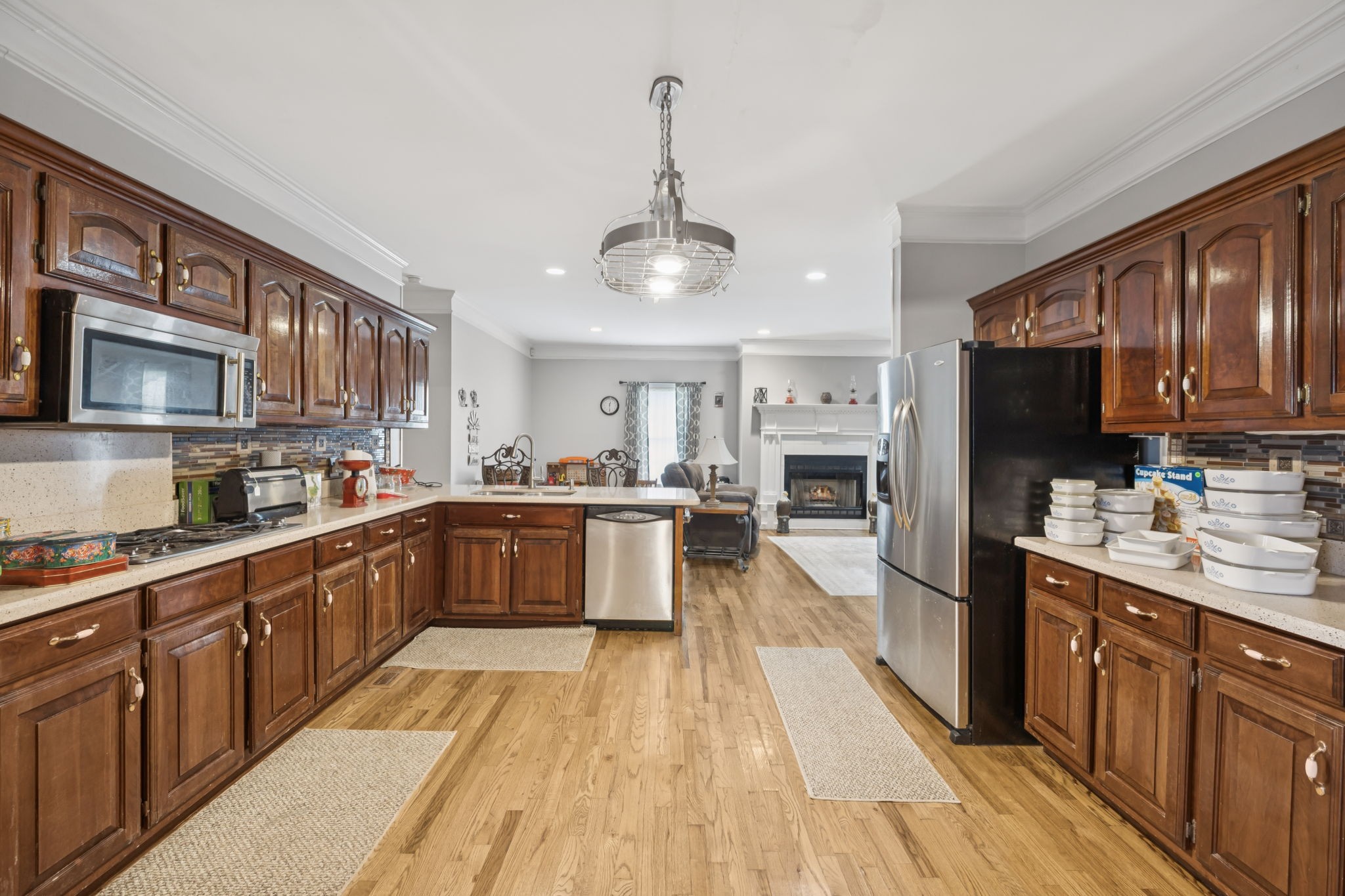 33 Bishop Road Lawrenceburg, TN 38464 - Photo 26 of 87 a large kitchen with stainless steel appliances granite countertop a stove top oven a sink dishwasher a dining table and chairs with wooden floor