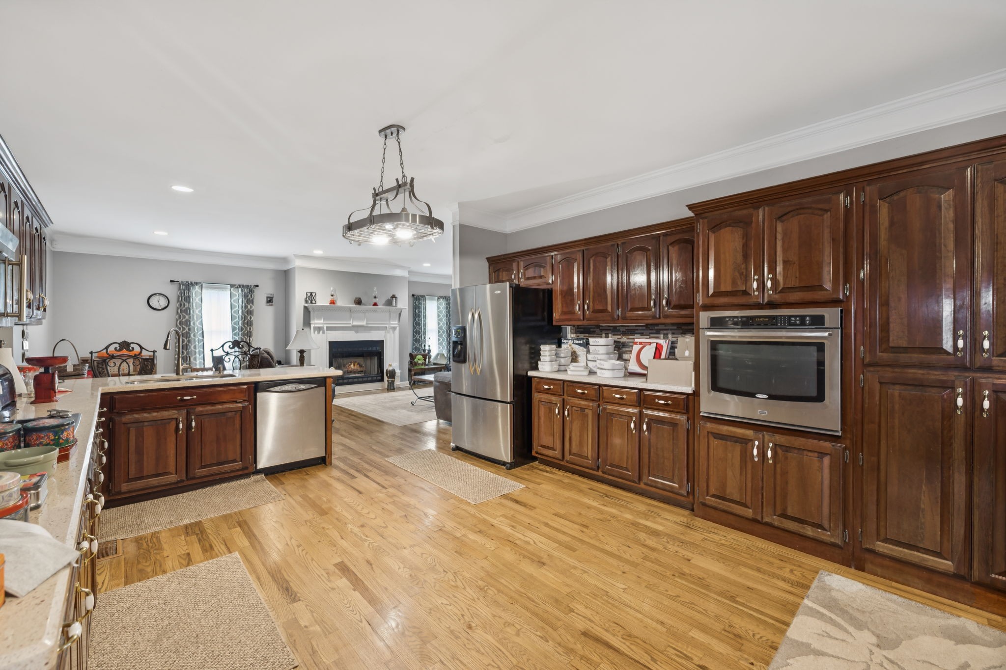 33 Bishop Road Lawrenceburg, TN 38464 - Photo 27 of 87 a large kitchen with stainless steel appliances granite countertop a refrigerator oven a sink dishwasher a dining table and chairs with wooden floor