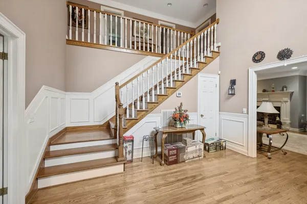 a view of a livingroom with furniture hardwood floor and staircase