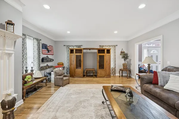 a living room with furniture a rug and gym equipment