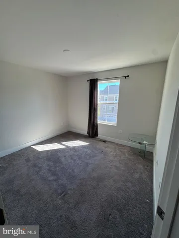 an empty room with a empty space and windows