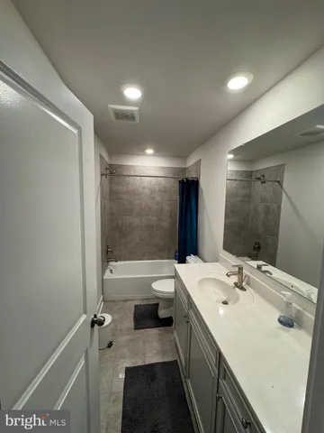 a bathroom with a double vanity sink toilet tub and shower