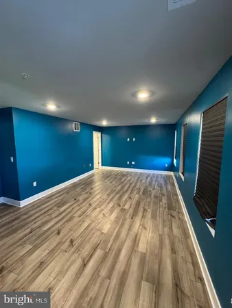 a view of room with wooden floor