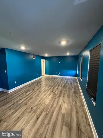 a view of room with wooden floor