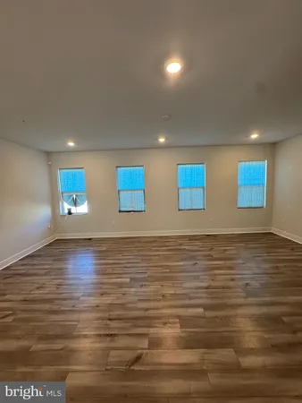a view of a room with an empty space and window