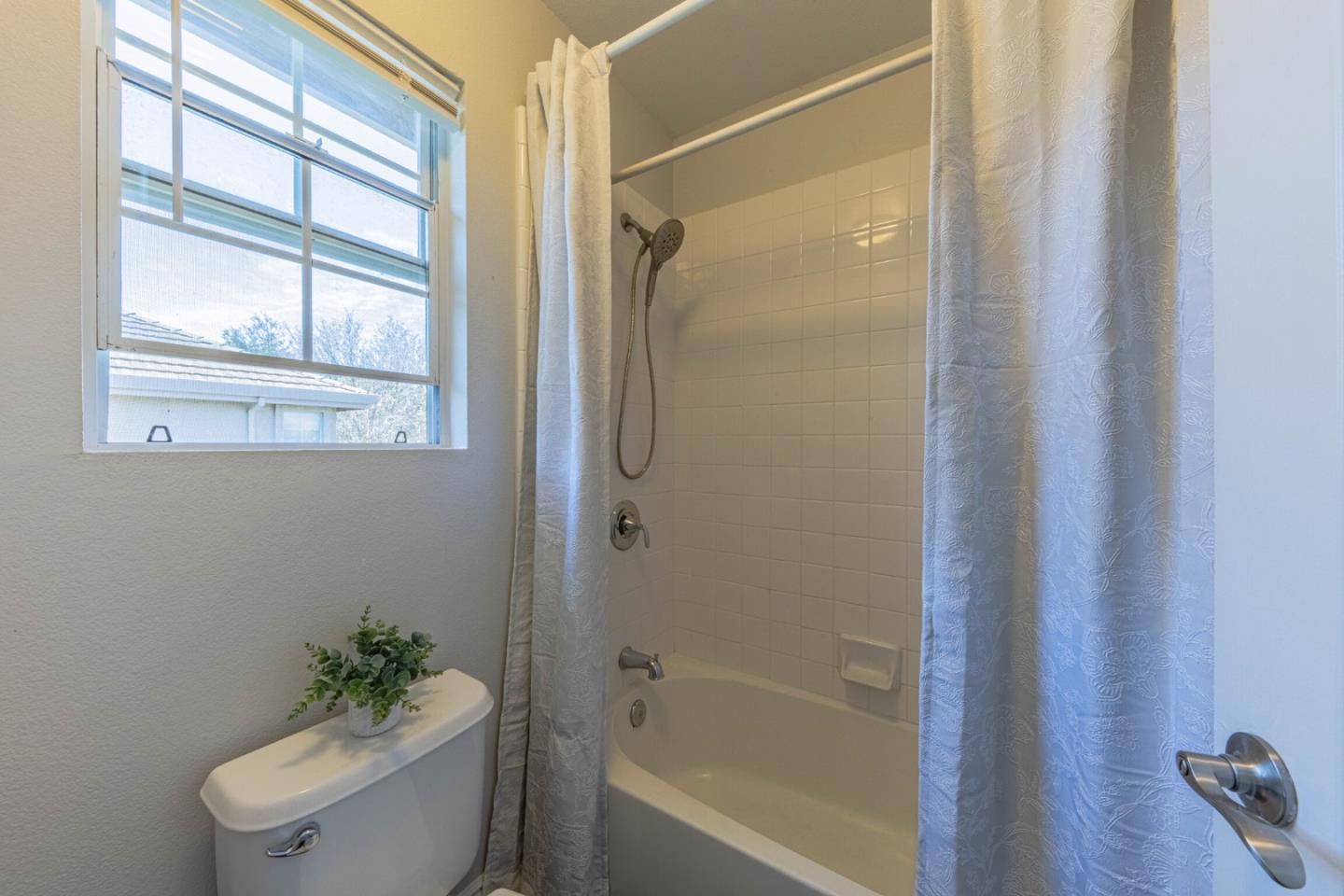 25215 Azalea Court Salinas, CA 93908 - Photo 39 of 48 a bathroom with a shower a toilet a window and a shower