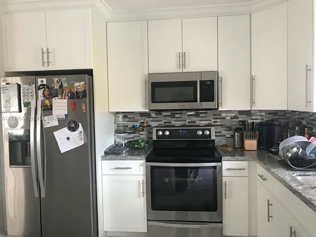 a kitchen with a stove and a microwave